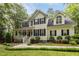 Traditional two-story home featuring a welcoming front porch, dormer windows, and mature landscaping at 118 Cavendish Ct, Hillsborough, NC 27278