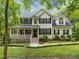 Charming two-story home with a welcoming front porch and lush landscaping at 118 Cavendish Ct, Hillsborough, NC 27278