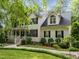 Attractive two-story house with front porch, black shutters, dormer windows, and landscaped yard at 118 Cavendish Ct, Hillsborough, NC 27278