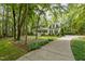 Two-story home with covered porch, mature trees, landscaped yard, and concrete driveway at 118 Cavendish Ct, Hillsborough, NC 27278