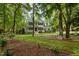 Charming two-story home featuring a welcoming front porch and surrounded by lush greenery and mature trees at 118 Cavendish Ct, Hillsborough, NC 27278