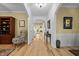 Bright hallway with hardwood floors and arched doorways, showcasing the home's layout at 118 Cavendish Ct, Hillsborough, NC 27278