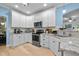 Stylish kitchen featuring white cabinets, stainless steel appliances, and granite countertops for meal preparation at 118 Cavendish Ct, Hillsborough, NC 27278