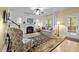 Comfortable living room with a fireplace, stylish decor, and plenty of natural light at 118 Cavendish Ct, Hillsborough, NC 27278