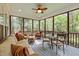 Comfortable screened porch with ceiling fan, outdoor furniture, and wooded view at 118 Cavendish Ct, Hillsborough, NC 27278