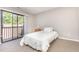 Bright bedroom featuring a bed with access to a private balcony offering outdoor views at 119 Brookberry Cir, Chapel Hill, NC 27517