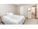 Cozy bedroom featuring a bed with white comforter, carpeted floors, and a doorway leading to another room at 119 Brookberry Cir, Chapel Hill, NC 27517