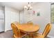 Bright dining area with a wood table, seating for four, and charming decor hung on the walls at 119 Brookberry Cir, Chapel Hill, NC 27517