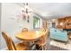 The dining area with window is open to the living room and kitchen with hardwood flooring throughout at 119 Brookberry Cir, Chapel Hill, NC 27517