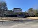 A large two-story home with a wrap-around porch and decorative details, surrounded by a well-manicured lawn at 119 Brookberry Cir, Chapel Hill, NC 27517