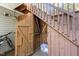 An exterior view of a storage shed under a wooden staircase, with a visible bicycle leaning to the side at 119 Brookberry Cir, Chapel Hill, NC 27517