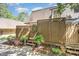 Exterior view of property showing a private wooden fence, staircase, and nicely planted landscaping at 119 Brookberry Cir, Chapel Hill, NC 27517
