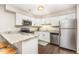 Bright kitchen features stainless steel appliances, granite countertops, white cabinets, and breakfast bar seating at 119 Brookberry Cir, Chapel Hill, NC 27517