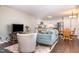 Inviting living room with neutral walls, hardwood floors, and seamless flow into a kitchen and dining area at 119 Brookberry Cir, Chapel Hill, NC 27517