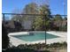 Community pool enclosed by a chain-link fence, offering a refreshing amenity for residents at 119 Brookberry Cir, Chapel Hill, NC 27517