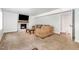Finished basement boasts a fireplace with mantel, neutral carpet, and a comfortable sectional sofa at 1209 Lanark Ct, Cary, NC 27511