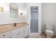 Bright bathroom features a white vanity with gold fixtures and tiled countertop, plus glass-enclosed shower at 1209 Lanark Ct, Cary, NC 27511