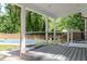 Covered deck with backyard view offers a great place to entertain next to the inground pool at 1209 Lanark Ct, Cary, NC 27511