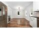 An open dining room featuring hardwood floors, lots of natural light, and white trim throughout at 1209 Lanark Ct, Cary, NC 27511