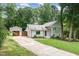 Charming home with a driveway leading to a detached garage, nestled amongst mature trees at 1209 Lanark Ct, Cary, NC 27511