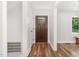 Bright and airy hallway features wood floors, fresh paint, and an entryway to welcome guests into the home at 1209 Lanark Ct, Cary, NC 27511