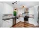 A bright and stylish kitchen featuring white cabinets, stainless steel appliances, and granite countertops at 1209 Lanark Ct, Cary, NC 27511