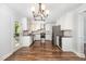A stylish kitchen featuring white cabinets, stainless steel appliances, and elegant hardwood floors at 1209 Lanark Ct, Cary, NC 27511