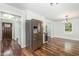 A spacious eat-in kitchen with stainless appliances, white cabinetry, and hardwood floors at 1209 Lanark Ct, Cary, NC 27511