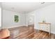 Open living area with hardwood floors, fresh paint, and natural light provides a cozy atmosphere for entertaining guests at 1209 Lanark Ct, Cary, NC 27511