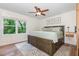 A spacious main bedroom with hardwood floors, a ceiling fan, lots of natural light, and neutral paint at 1209 Lanark Ct, Cary, NC 27511
