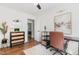 Home office with dark desk and drawers, decor items, hardwood floors, and a comfortable chair at 1209 Lanark Ct, Cary, NC 27511