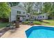 Inviting backyard oasis featuring a sparkling in-ground pool, patio seating, and lush landscaping at 1209 Lanark Ct, Cary, NC 27511
