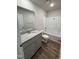 Bathroom featuring vanity with gray cabinets, granite countertop, a mirror, and a shower-tub combo at 128 Coharie Dr, Lillington, NC 27546
