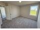 Bedroom featuring neutral walls, plush carpeting, a large window, and a door to the closet at 128 Coharie Dr, Lillington, NC 27546
