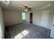 Bedroom featuring a ceiling fan, a tray ceiling, plush carpeting, and natural light at 128 Coharie Dr, Lillington, NC 27546