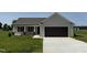 Charming single-story home with neutral siding, attached garage, and well-manicured lawn at 128 Coharie Dr, Lillington, NC 27546