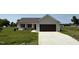 Charming single-story home with neutral siding, attached garage, and well-manicured lawn at 128 Coharie Dr, Lillington, NC 27546