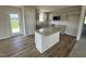 Modern kitchen with stainless steel appliances, a center island, granite countertops, and ample cabinet space at 128 Coharie Dr, Lillington, NC 27546
