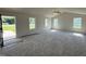 Bright living room featuring carpet floors, vaulted ceiling with fan, and multiple windows offering ample natural light at 128 Coharie Dr, Lillington, NC 27546
