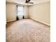 Spacious bedroom with neutral carpet, ceiling fan, and window for natural light at 141 Jones Franklin Rd # G, Raleigh, NC 27606