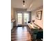 Cozy dining area featuring a wooden table, modern chairs, and natural light from glass doors at 141 Jones Franklin Rd # G, Raleigh, NC 27606