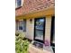 Close-up of the front door with a wreath and potted flowers at 141 Jones Franklin Rd # G, Raleigh, NC 27606