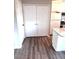 Hallway with wood-look flooring, double-door storage, and convenient access to the kitchen at 141 Jones Franklin Rd # G, Raleigh, NC 27606