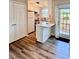 Open kitchen with white cabinets, stainless steel appliances, and a breakfast bar at 141 Jones Franklin Rd # G, Raleigh, NC 27606