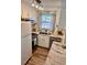 Bright kitchen with stainless steel appliances, white cabinets, and modern countertops at 141 Jones Franklin Rd # G, Raleigh, NC 27606