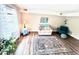 Bright living room with wood floors, neutral walls, and a cozy seating area at 141 Jones Franklin Rd # G, Raleigh, NC 27606