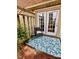 Outdoor patio area with a chair and a decorative rug at 141 Jones Franklin Rd # G, Raleigh, NC 27606