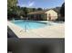 A beautiful outdoor pool with a building and picnic table and lush green landscaping in the background at 141 Jones Franklin Rd # G, Raleigh, NC 27606
