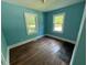 Light filled bedroom with wood floors and two windows at 1525 Hargrove St, Rocky Mount, NC 27801
