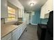 Kitchen features white cabinets, laminate countertops, and modern appliances at 1525 Hargrove St, Rocky Mount, NC 27801